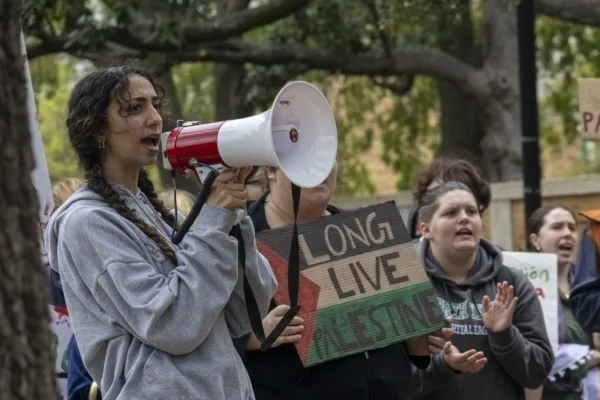 This photo shows a woman shouting into a bullhorn at a pro-Palestine protest.